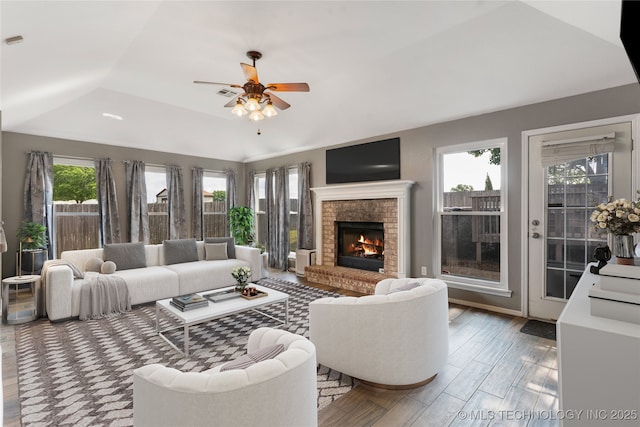 3933 S 199th E Ave, Broken Arrow, OK 74014 - living area with plenty of natural light, a ceiling fan, a brick fireplace, and a tray ceiling