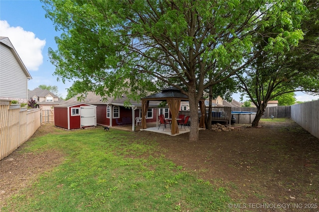 3933 S 199th E Ave, Broken Arrow, OK 74014 - view of yard featuring an outdoor structure, a gazebo, a shed, and a fenced backyard
