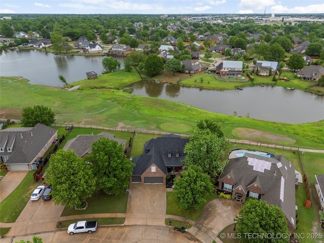 drone / aerial view featuring a water view and a residential view