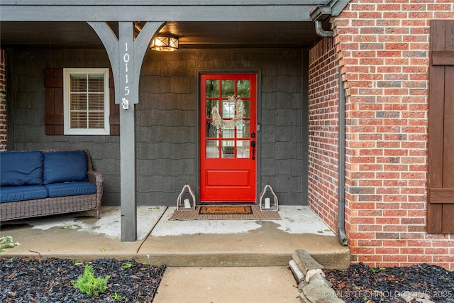 entrance to property featuring brick siding