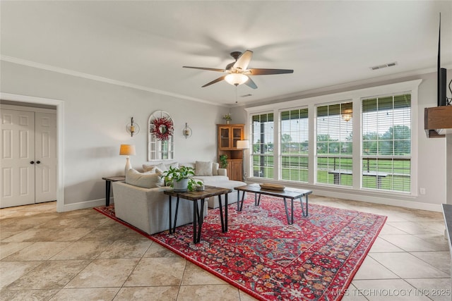 living room featuring visible vents, crown molding, tile patterned flooring, baseboards, and a ceiling fan