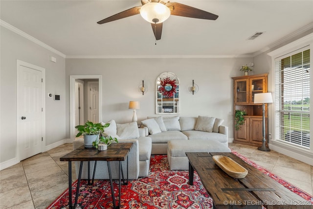 living area featuring light tile patterned floors, ornamental molding, a ceiling fan, and visible vents