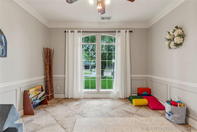 playroom with ceiling fan, visible vents, ornamental molding, and a wealth of natural light