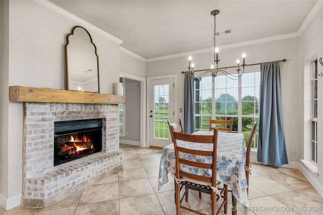 dining area with an inviting chandelier, ornamental molding, visible vents, a brick fireplace, and baseboards