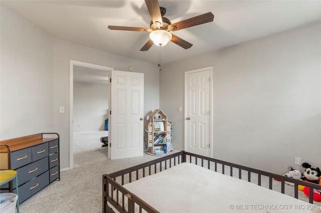 bedroom with a ceiling fan, baseboards, and light colored carpet