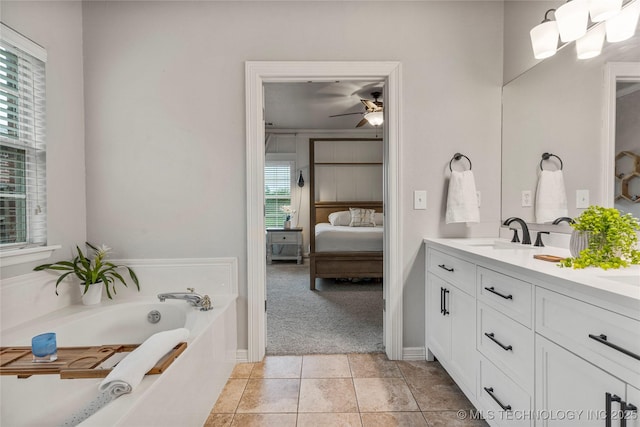 ensuite bathroom featuring double vanity, a ceiling fan, a garden tub, a sink, and connected bathroom