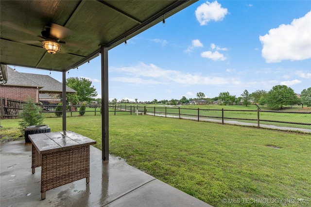 view of yard with a fenced backyard, a patio area, and a rural view