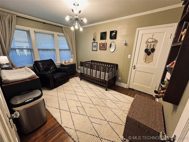 bedroom with crown molding, baseboards, wood finished floors, and a notable chandelier