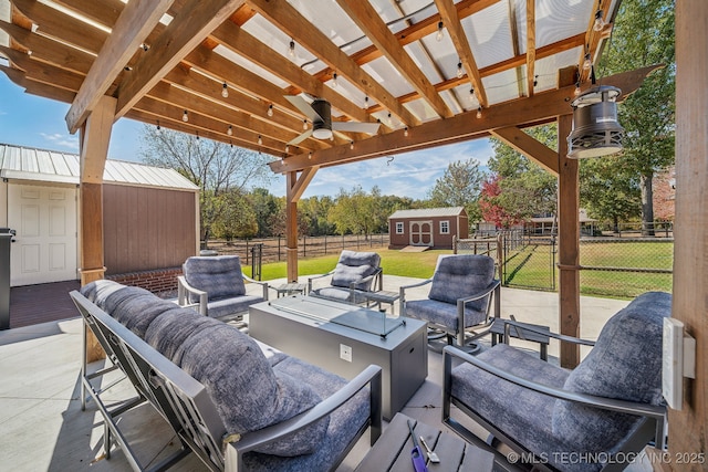 9998 E 460th Rd, Claremore, OK 74017 - view of patio with an outdoor living space with a fire pit, a storage shed, an outdoor structure, and a ceiling fan