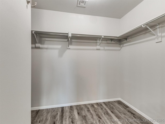spacious closet with visible vents and wood finished floors