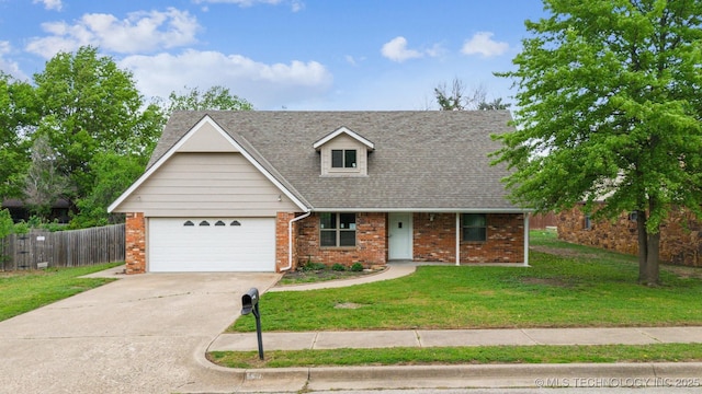 view of front of home with driveway, brick siding, fence, a front lawn, and an attached garage