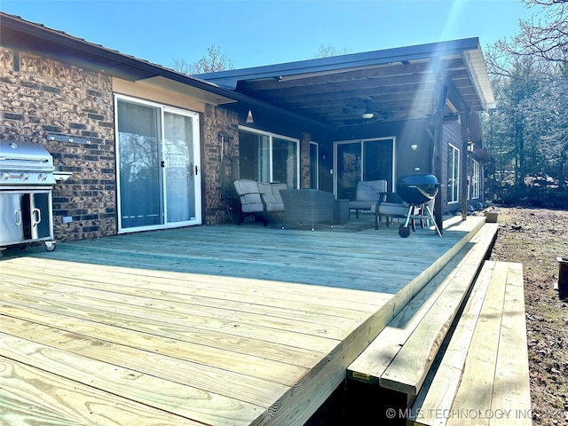 wooden deck featuring an outdoor hangout area and area for grilling