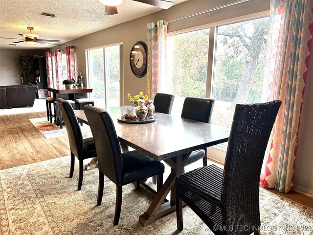1082 Gaines Creek Loop, Eufaula, OK 74432 - dining area with ceiling fan, wood finished floors, and a textured ceiling