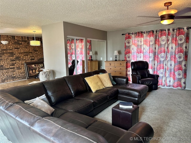 living room featuring carpet floors, a textured ceiling, and brick wall
