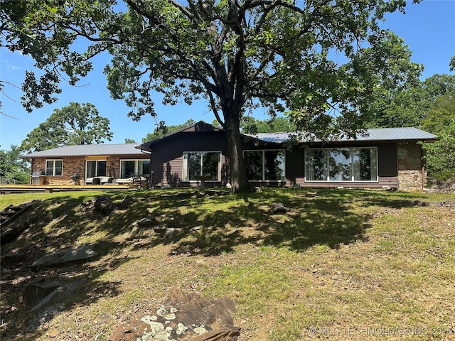 1082 Gaines Creek Loop, Eufaula, OK 74432 - rear view of house featuring a lawn and stone siding