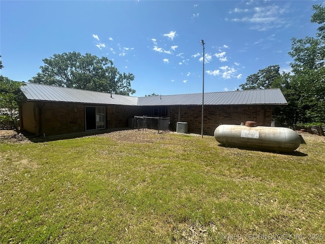 1082 Gaines Creek Loop, Eufaula, OK 74432 - rear view of house featuring central AC unit, a yard, and metal roof