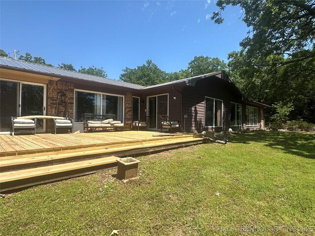1082 Gaines Creek Loop, Eufaula, OK 74432 - back of house with a lawn, a deck, and metal roof