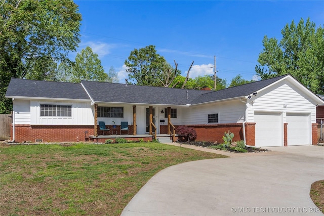 single story home with a front lawn, brick siding, a garage, covered porch, and driveway