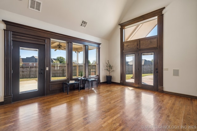doorway featuring a ceiling fan, visible vents, french doors, and wood finished floors