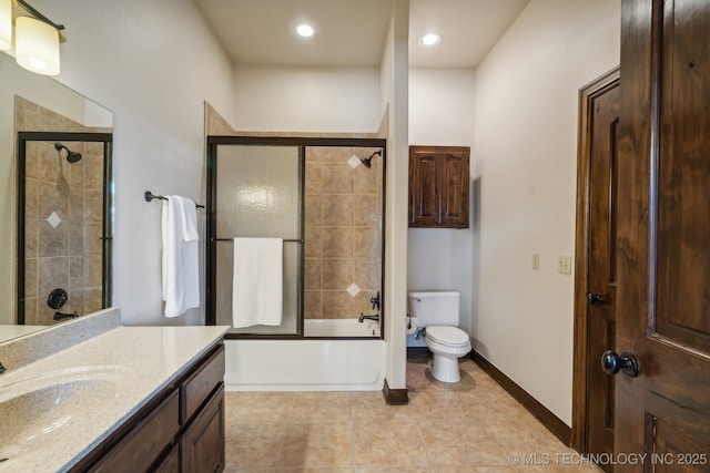 full bath with vanity, toilet, baseboards, tile patterned floors, and combined bath / shower with glass door