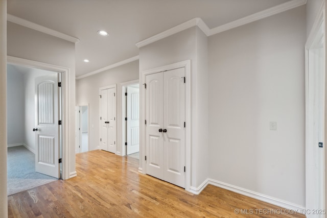hall with baseboards, ornamental molding, recessed lighting, and light wood-style flooring
