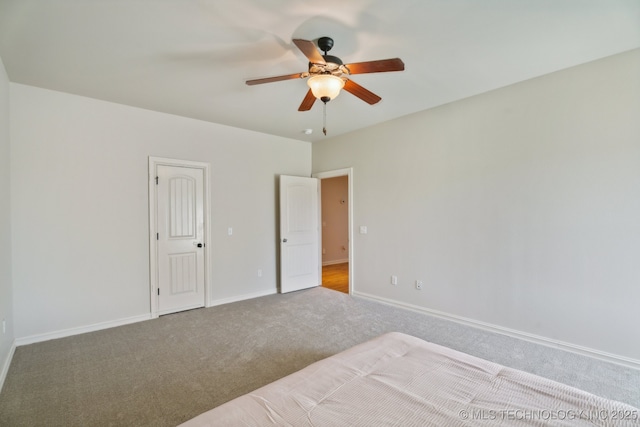 unfurnished bedroom featuring baseboards, ceiling fan, and carpet flooring