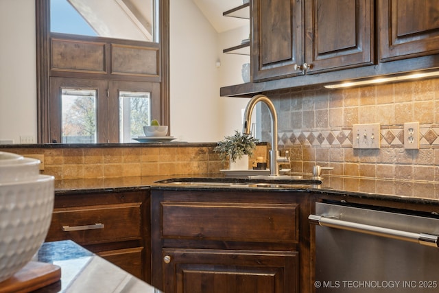 kitchen featuring dark brown cabinets, a sink, dishwasher, backsplash, and vaulted ceiling