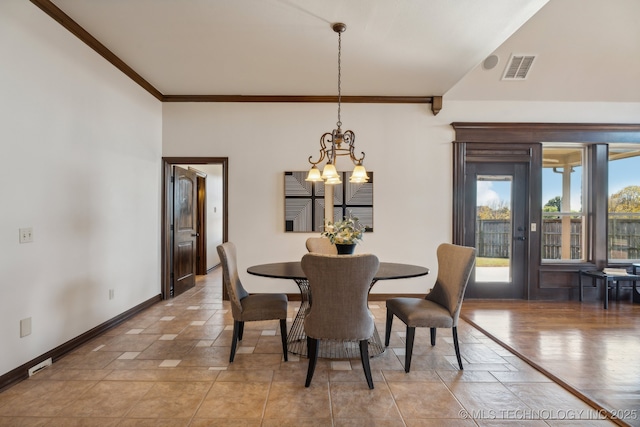 dining space featuring crown molding, baseboards, an inviting chandelier, and visible vents