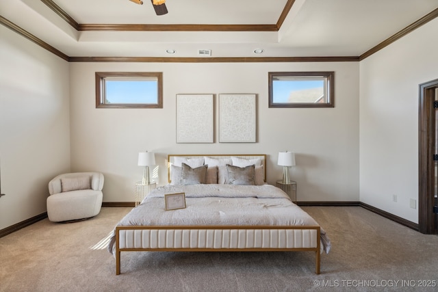 bedroom featuring crown molding, a tray ceiling, visible vents, and carpet floors