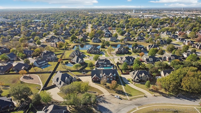 birds eye view of property with a water view and a residential view