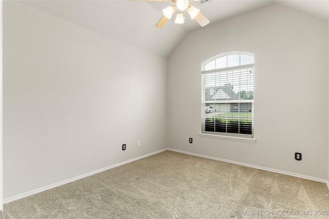 carpeted empty room featuring ceiling fan, baseboards, and lofted ceiling