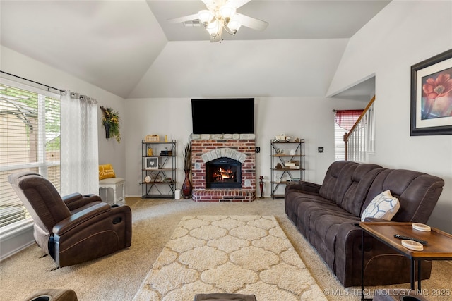 living room with a ceiling fan, plenty of natural light, carpet, and vaulted ceiling