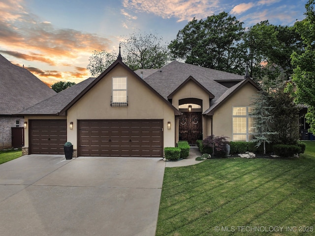view of front facade featuring a garage, stucco siding, and concrete driveway