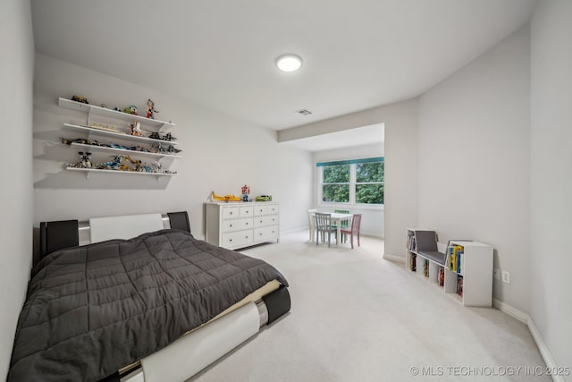 carpeted bedroom featuring baseboards and visible vents