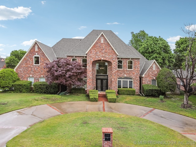 traditional-style house with brick siding and a front yard