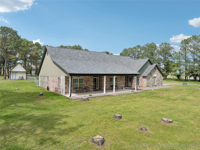 19978 E Murrell Rd, Tahlequah, OK 74464 - rear view of property with brick siding, roof with shingles, a lawn, and a detached garage