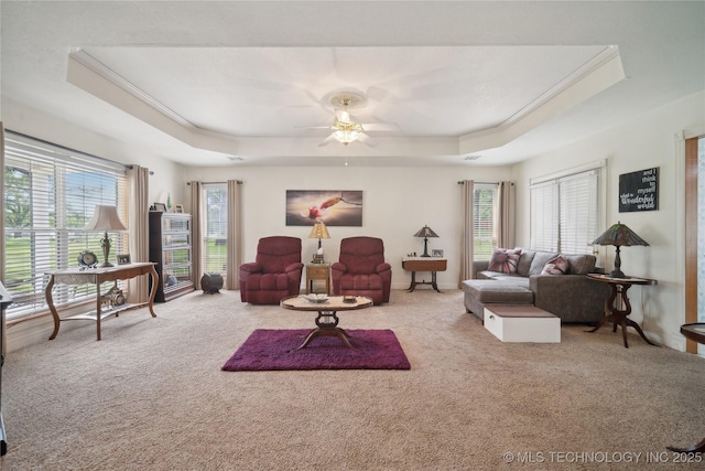 19978 E Murrell Rd, Tahlequah, OK 74464 - carpeted living area with a tray ceiling, crown molding, plenty of natural light, and a ceiling fan