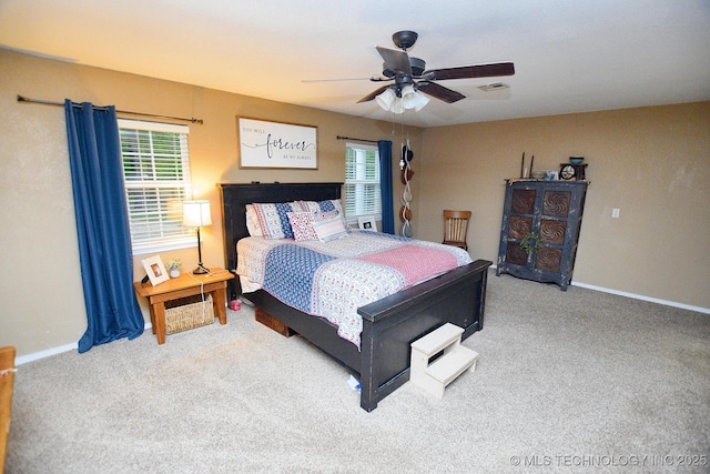 bedroom with carpet floors, multiple windows, and baseboards