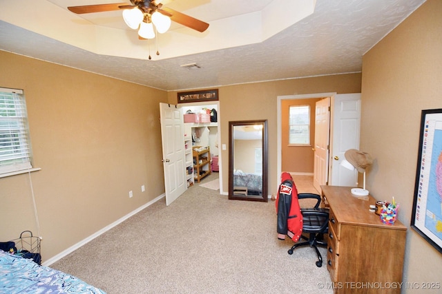 carpeted bedroom featuring baseboards, multiple windows, a textured ceiling, and visible vents