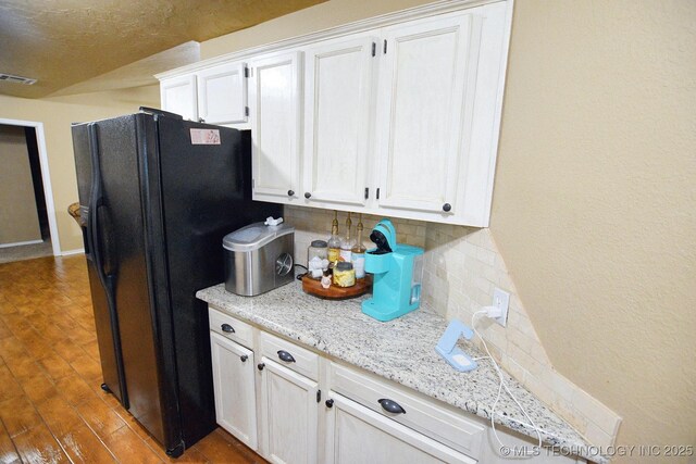 26204 S 532nd Rd, Park Hill, OK 74451 - kitchen with black refrigerator with ice dispenser, tasteful backsplash, white cabinets, and dark wood-style floors