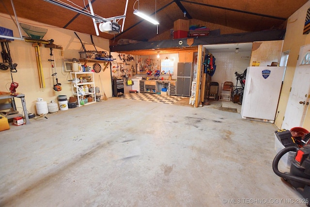 26204 S 532nd Rd, Park Hill, OK 74451 - garage featuring a workshop area, freestanding refrigerator, and a garage door opener