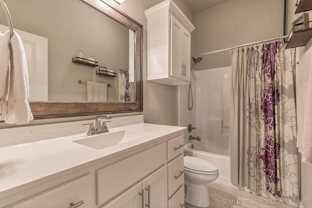 bathroom featuring vanity, shower / tub combo with curtain, and toilet