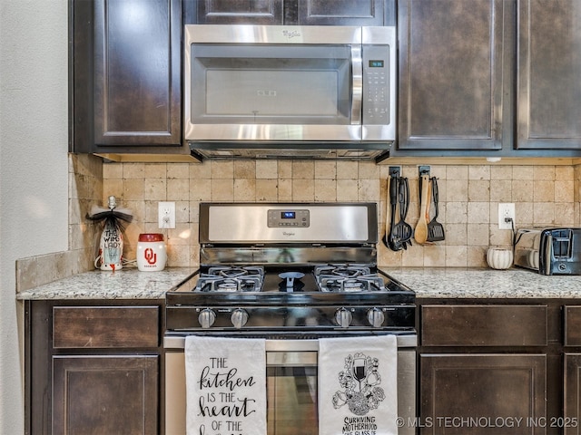 kitchen with backsplash, stainless steel appliances, dark brown cabinetry, and a toaster