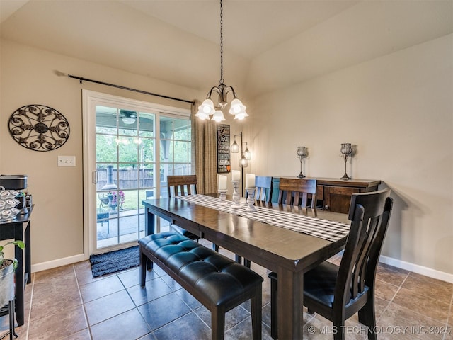 dining space featuring an inviting chandelier, baseboards, and lofted ceiling