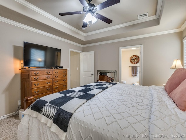 carpeted bedroom featuring crown molding, baseboards, a tray ceiling, and visible vents