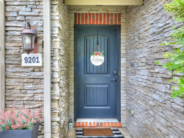 entrance to property with stone siding