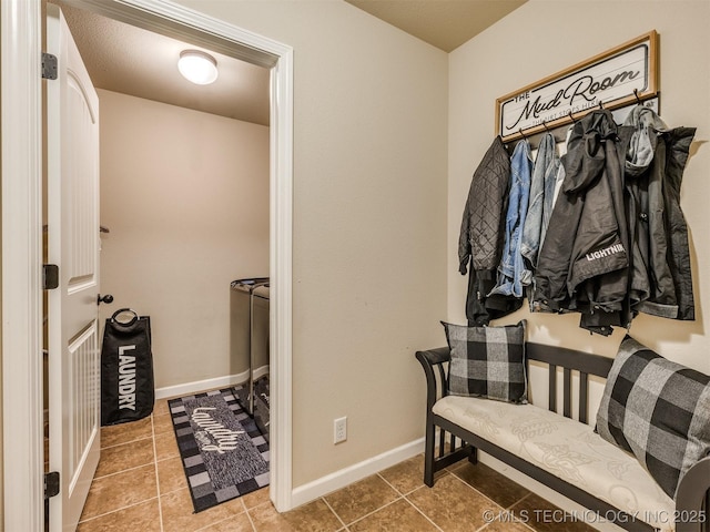 mudroom with tile patterned floors and baseboards