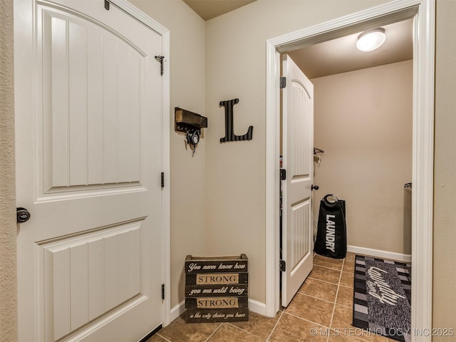 entryway featuring tile patterned flooring and baseboards