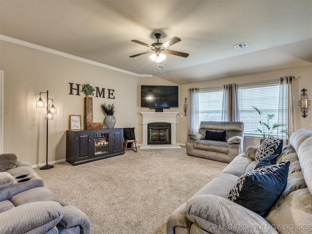 living area featuring a fireplace with raised hearth, ceiling fan, visible vents, and light carpet