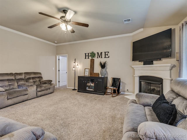 living room featuring ceiling fan, carpet floors, baseboards, visible vents, and ornamental molding